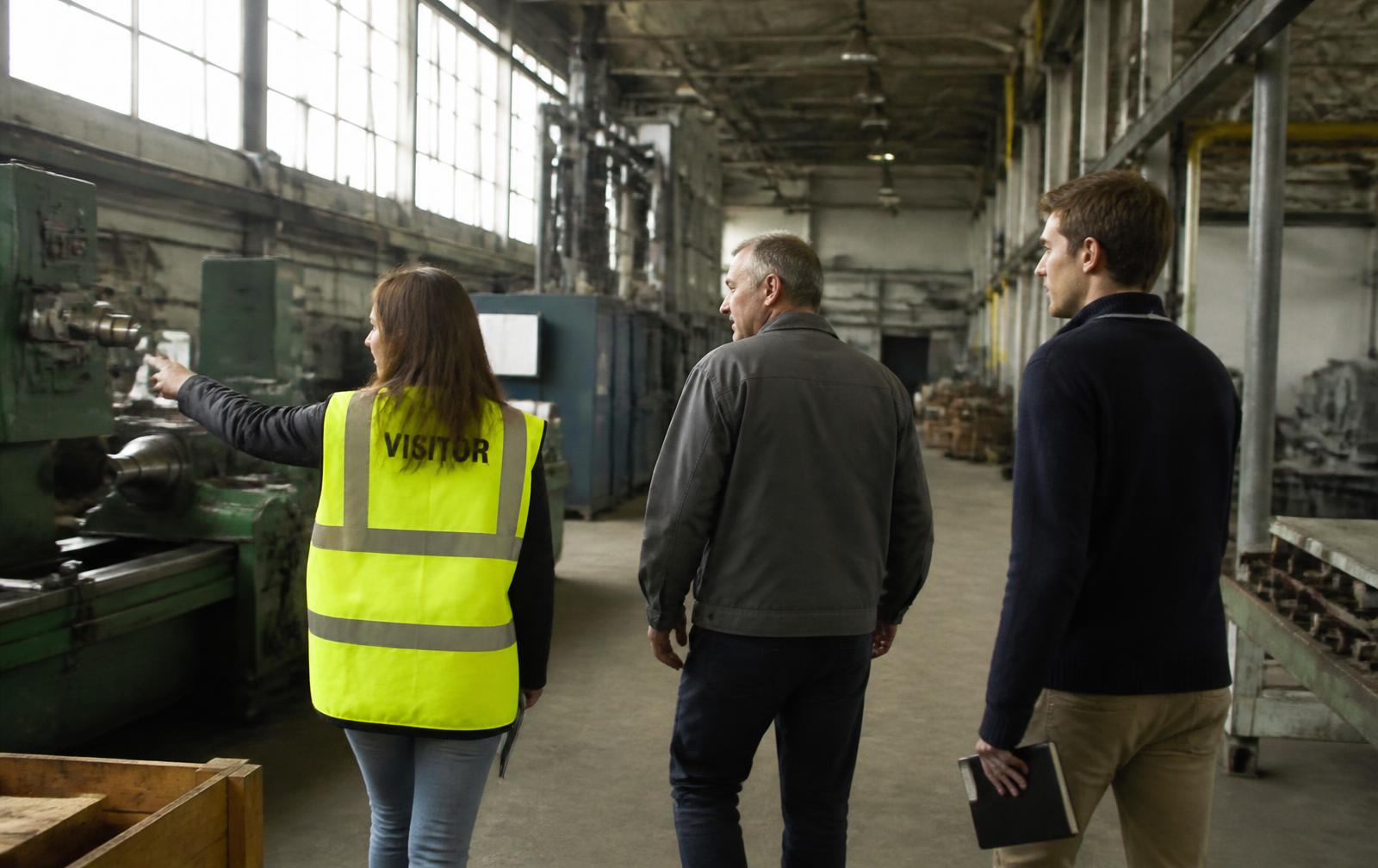 Lab team walking a factory floor with a plant manager