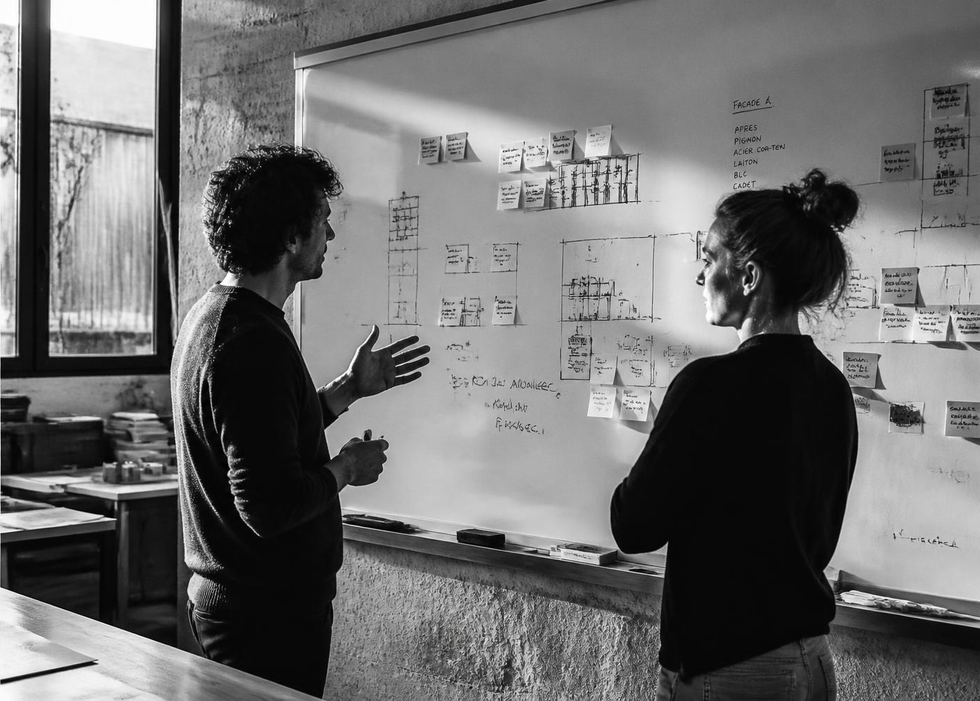 A founder explaining a product decision at a whiteboard